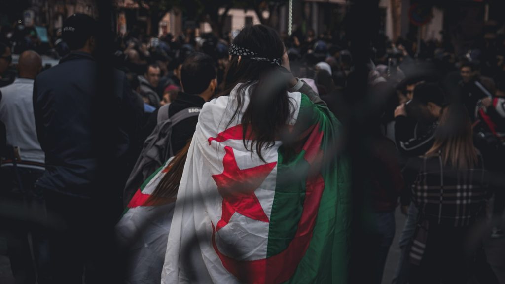 Woman wrapped in the flag of Algeria.