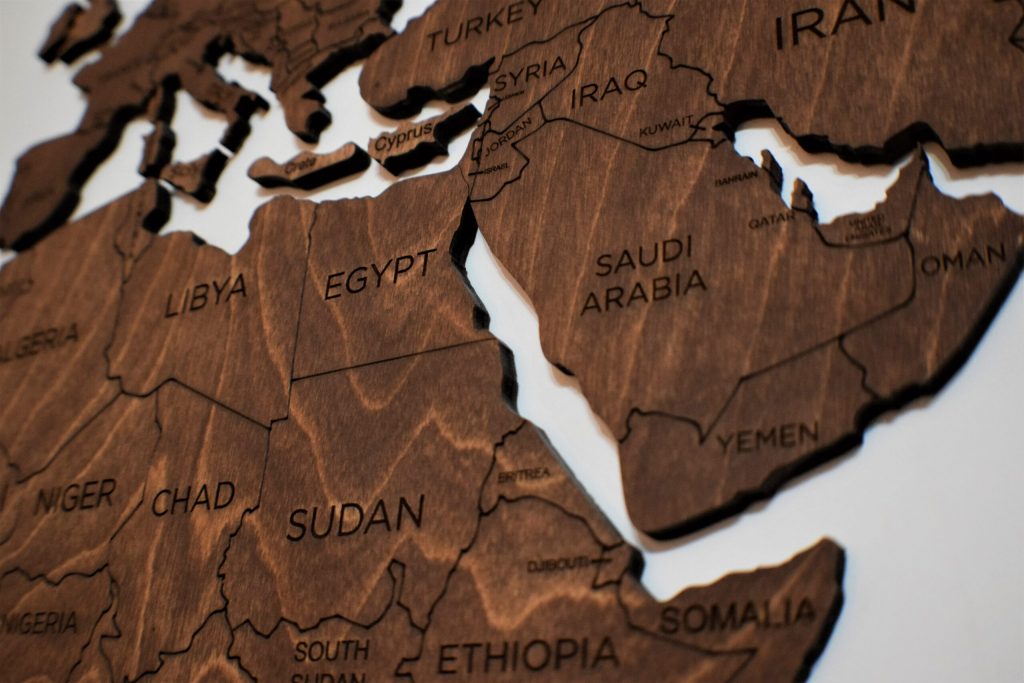 A wooden map displaying Libya and other countries in North Africa and the Middle East