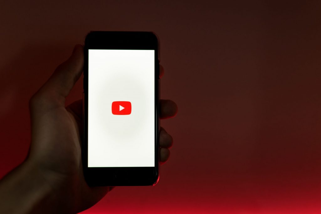 A phone displaying the YouTube app. 